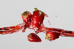 Four strawberries and red juice splash royalty free stock images Four strawberries and red juice splash royalty free stock images