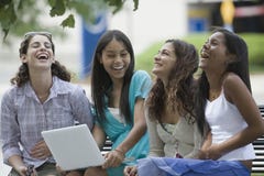 Four Teenage Girls Sitting And Smiling Stock Images Four Teenage Girls Sitting And Smiling Stock Images