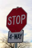 Four Way Stop Sign Against Cloudy Sky royalty free stock photos Four Way Stop Sign Against Cloudy Sky royalty free stock photos