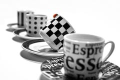 Four White and Black Printed Teacup on a Round Ceramic Saucer Royalty Free Stock Images Four White and Black Printed Teacup on a Round Ceramic Saucer Royalty Free Stock Images