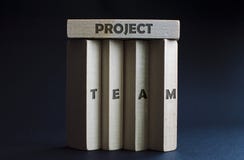 Four vertical wood blocks as a team holding one horizontal wood block above them as a project. Concept of business, team, teaming Royalty Free Stock Photos Four vertical wood blocks as a team holding one horizontal wood block above them as a project. Concept of business, team, teaming Royalty Free Stock Photos