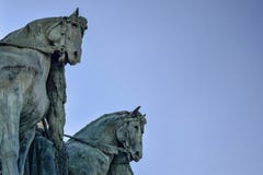 Side view on statue horses of the chieftains of the Magyars against a blue sky. Fragment of the Millennium Monument on the Heroes stock photography Side view on statue horses of the chieftains of the Magyars against a blue sky. Fragment of the Millennium Monument on the Heroes stock photography