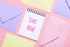 Frame from colorful envelopes and notepad on pink table top view. stock photos Frame from colorful envelopes and notepad on pink table top view. stock photos
