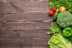 Frame of green and red fresh vegetables on wooden background, top view stock image Frame of green and red fresh vegetables on wooden background, top view stock image