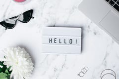 Frame Hello on a marble table with a flower and laptop royalty free stock images Frame Hello on a marble table with a flower and laptop royalty free stock images