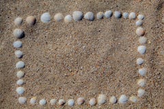 The frame is laid out on the sand from the shells, of different colors and shapes. stock image The frame is laid out on the sand from the shells, of different colors and shapes. stock image
