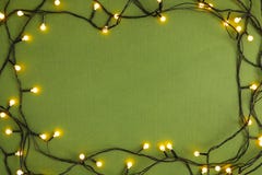 Frame Made With Christmas Lights On Green Background Stock Photography