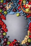 Frame of Various summer berries on rustic background stock photo Frame of Various summer berries on rustic background stock photo