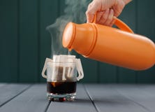 Framställning av droppandekaffe med varmvatten från termoset Royaltyfri Foto Framställning av droppandekaffe med varmvatten från termoset Royaltyfri Foto