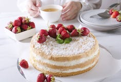 Frau, die grünen Tee trinkt und geschmackvollen Schwammkuchen mit Erdbeeren isst Entspannengetr?nktee der Frau lizenzfreie stockbilder Frau, die grünen Tee trinkt und geschmackvollen Schwammkuchen mit Erdbeeren isst Entspannengetr?nktee der Frau lizenzfreie stockbilder
