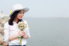 Free Careless Causual Beauty By Beach Ocean Lake River Enjoy Relax Time In Summer Spring Park Smile On Her Face Hold A Flower Stock Photo