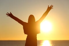 Free woman raising arms watching sun at sunrise royalty free stock photo Free woman raising arms watching sun at sunrise royalty free stock photo