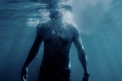 Freediver man swimming to the surface of sea. stock photo Freediver man swimming to the surface of sea. stock photo