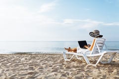 Freelancer girl working on vacation, in front of the beautiful sea, sitting with a laptop on the ocean, isolated place for text royalty free stock photo Freelancer girl working on vacation, in front of the beautiful sea, sitting with a laptop on the ocean, isolated place for text royalty free stock photo
