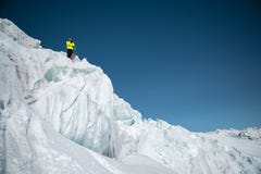 A freerider skier in complete outfit stands on a glacier in the North Caucasus. Skier preparing before jumping from the stock image A freerider skier in complete outfit stands on a glacier in the North Caucasus. Skier preparing before jumping from the stock image