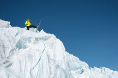 A freerider skier in complete outfit stands on a glacier in the North Caucasus. Skier preparing before jumping from the stock photo A freerider skier in complete outfit stands on a glacier in the North Caucasus. Skier preparing before jumping from the stock photo