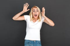 Freestyle. Woman standing isolated on black wall hands up screaming scared royalty free stock photos Freestyle. Woman standing isolated on black wall hands up screaming scared royalty free stock photos