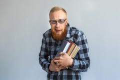 freestyle Ώριμο άτομο eyeglasses που στέκονται απομονωμένα στο γκρι που αγκαλιάζει το χαμόγελο βιβλίων nerdy στοκ εικόνα freestyle Ώριμο άτομο eyeglasses που στέκονται απομονωμένα στο γκρι που αγκαλιάζει το χαμόγελο βιβλίων nerdy στοκ εικόνα