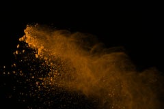Freeze motion of gold powder explosions isolated on black background. colored dust explosive on dark background. Colorful cloud s stock photos Freeze motion of gold powder explosions isolated on black background. colored dust explosive on dark background. Colorful cloud s stock photos