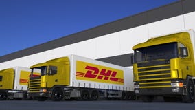 Freight Semi Trucks With Dhl Express Logo Loading Or Unloading At Warehouse Dock Seamless Loop Editorial Animation - 