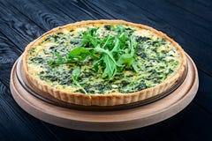 Traditional Spinach Quiche on dark wooden background stock image Traditional Spinach Quiche on dark wooden background stock image