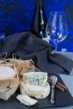 French red wine and soft cheeses on black stone platter stock photography French red wine and soft cheeses on black stone platter stock photography