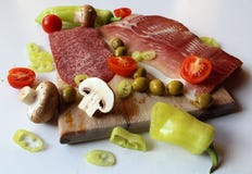 Fresh food - wooden cutting board with slices of salami and ham, olives, mushrooms and cut tomatoes and green peppers Stock Photos Fresh food - wooden cutting board with slices of salami and ham, olives, mushrooms and cut tomatoes and green peppers Stock Photos