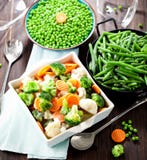 Fresh frozen vegetables on wooden background close up stock photo Fresh frozen vegetables on wooden background close up stock photo