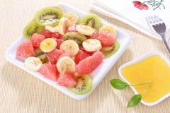 Fresh Fruits Salad On White Plate With Honey Stock Photos