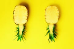 Fresh half sliced pineapple on yellow background. Top View. Copy Space. Bright pineapples pattern for minimal style. Pop royalty free stock photography Fresh half sliced pineapple on yellow background. Top View. Copy Space. Bright pineapples pattern for minimal style. Pop royalty free stock photography