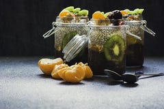 Fresh and healthy chia pudding in a jar with fruits and nuts on the top stock photo Fresh and healthy chia pudding in a jar with fruits and nuts on the top stock photo