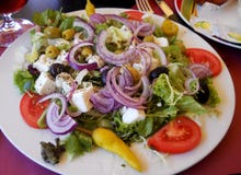 Fresh and healthy salad with red onion, lettuce,tomato, feta cheese, olives and pepper stock image Fresh and healthy salad with red onion, lettuce,tomato, feta cheese, olives and pepper stock image