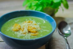 Fresh mashed soup with broccoli and green beans in a blue plate on a wooden background stock image Fresh mashed soup with broccoli and green beans in a blue plate on a wooden background stock image