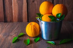 Fresh orange in aluminum basket on wooden background. stock photo Fresh orange in aluminum basket on wooden background. stock photo