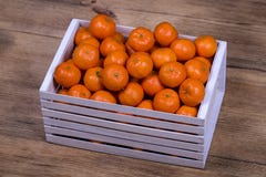 Fresh orange, tangerine fruit, mandarin pattern background in a wooden box . Concept of healthy, organic, vegan food Stock Photos Fresh orange, tangerine fruit, mandarin pattern background in a wooden box . Concept of healthy, organic, vegan food Stock Photos