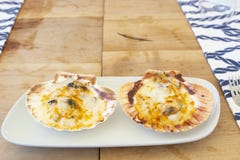 Delicious oysters with melted cheese on top stock photo Delicious oysters with melted cheese on top stock photo