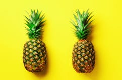 Fresh pineapples on yellow background. Top View. Pop art design, creative concept. Copy Space. Bright pineapple pattern stock image Fresh pineapples on yellow background. Top View. Pop art design, creative concept. Copy Space. Bright pineapple pattern stock image