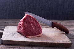 Fresh Raw Prime Black Angus Tenderloin Beef Steaks On Wooden Cutting Board With A Knife Stock Image