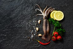 Fresh raw squid seafood herbs and spices with lemon tomato garlic stock image Fresh raw squid seafood herbs and spices with lemon tomato garlic stock image