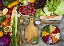 Fresh raw vegetables with cutting board on wooden background cop stock photos Fresh raw vegetables with cutting board on wooden background cop stock photos