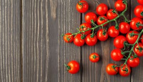 Fresh Red Cherry Tomatoes On Dark Rustic Wooden Background, Top View, Copy Space For Text Royalty Free Stock Photo