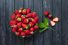 Fresh Red Strawberry In A Bowl On A Dark Rustic Wooden Background, Top View With Copy Space. Royalty Free Stock Photography Fresh Red Strawberry In A Bowl On A Dark Rustic Wooden Background, Top View With Copy Space. Royalty Free Stock Photography