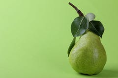 Ripe pear green on a green background with a place for writing royalty free stock photo Ripe pear green on a green background with a place for writing royalty free stock photo