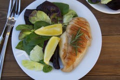 Fresh salad with chicken grilled breast and lemons. top view, healthy food plate. Wooden table. stock photo Fresh salad with chicken grilled breast and lemons. top view, healthy food plate. Wooden table. stock photo