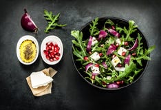 Fresh spring salad with rucola, feta cheese and red onion stock image Fresh spring salad with rucola, feta cheese and red onion stock image