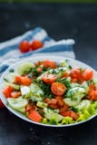 Fresh spring vegetable salad on a black background, close-up royalty free stock photography Fresh spring vegetable salad on a black background, close-up royalty free stock photography