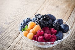 Fresh summer berries and fruits in glass bowl on wooden rustic Royalty Free Stock Image Fresh summer berries and fruits in glass bowl on wooden rustic Royalty Free Stock Image