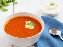 Fresh Tomato Soup. Seasonal Summer Dish. Located On A Vintage White Background. Nearby Is A Spoon On A Blue Paper Towel And Sauce Royalty Free Stock Photography