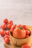 Fresh yellow and red cherry tomatoes in a basket on a cement board, close up, copy space, top view royalty free stock photos Fresh yellow and red cherry tomatoes in a basket on a cement board, close up, copy space, top view royalty free stock photos