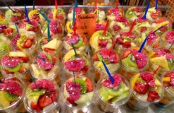 Freshly sliced fruit mixture in plastic cups on display royalty free stock photo Freshly sliced fruit mixture in plastic cups on display royalty free stock photo